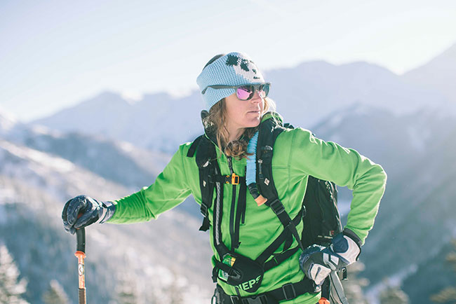 Ashley looks back on a sunny day while ski touring