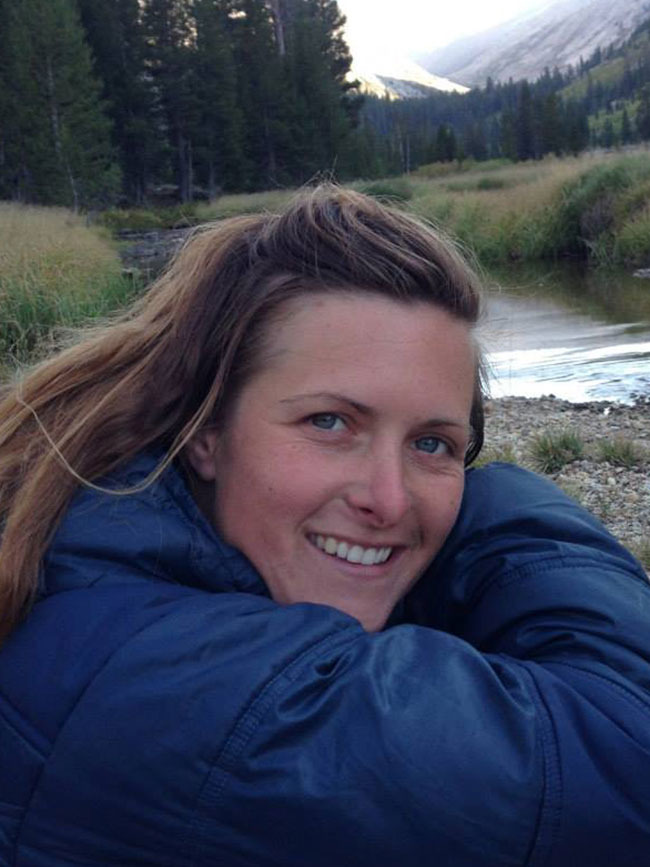 Cairn Project Ambassador Dashielle Vawter smiles next to a mountain river