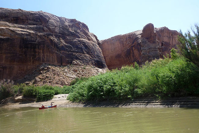 The Green River with red desert peaks in the background
