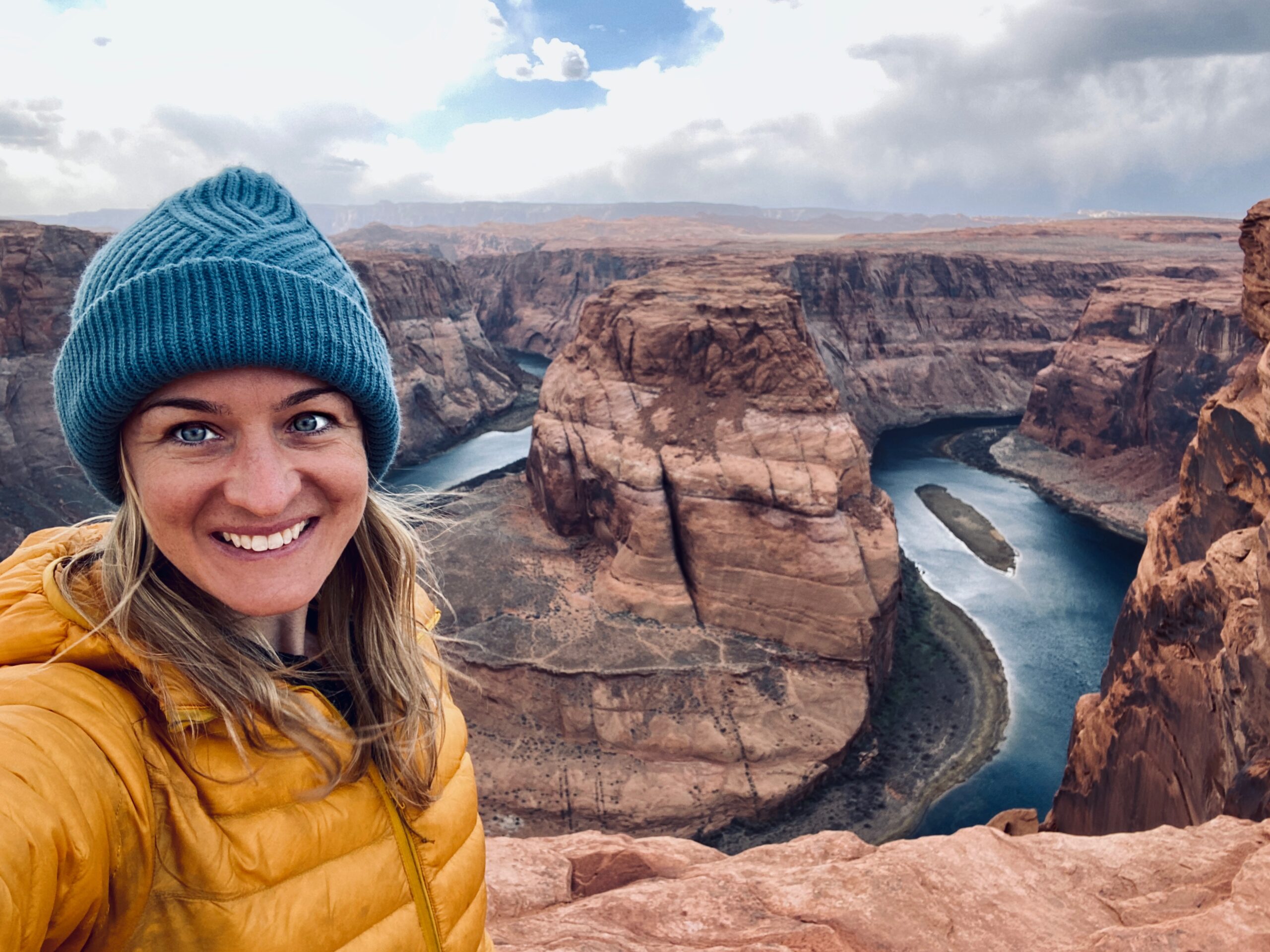 A Cairn Project ambassador smiles for a selfie in front of Horseshoe Bend