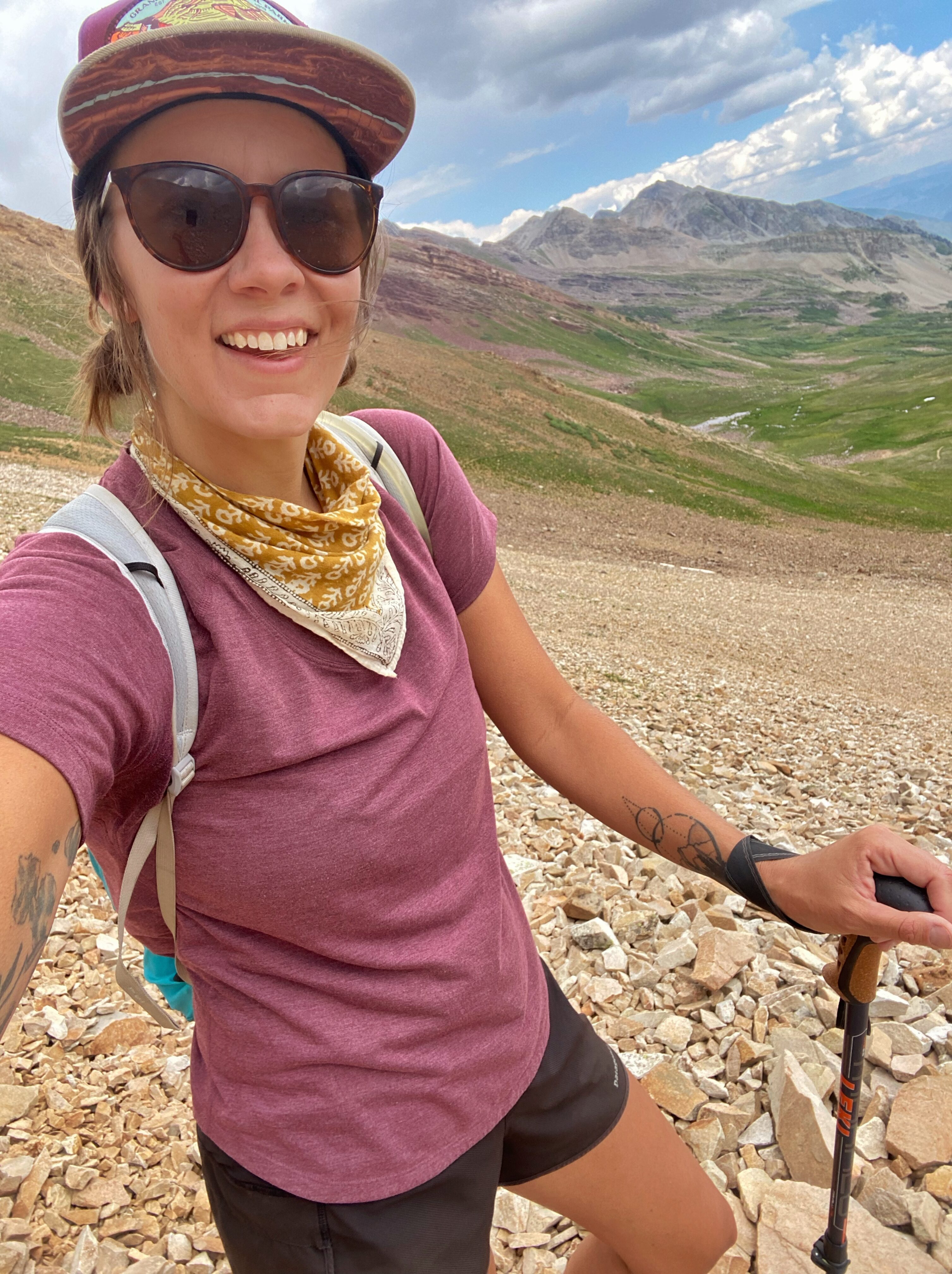 Cairn Project Ambassador Stephanie Kichler takes a selfie on a talus field in the mountains